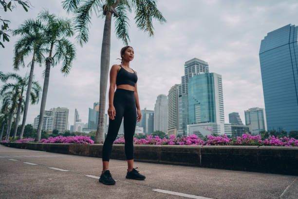istock Female athlete taking a break from jogging 1357068260