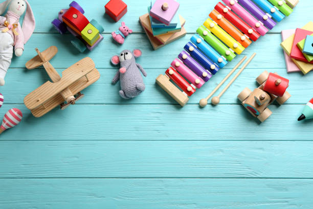 istock Different toys on light blue wooden background, flat lay. Space for text 1357070644