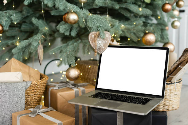 istock Laptop. Christmas tree and gifts on background 1357072810