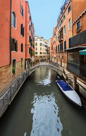 Venice, Italy, April 1, 2016: View of the water canal surrounded by picturesque houses in Venice. The entire Venetian Lagoon is listed as UNESCO World Heritage Site.