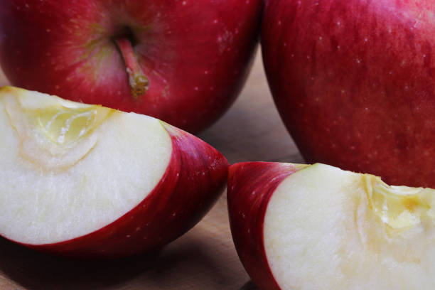 istock sliced red apple on a chopping board 1357074947