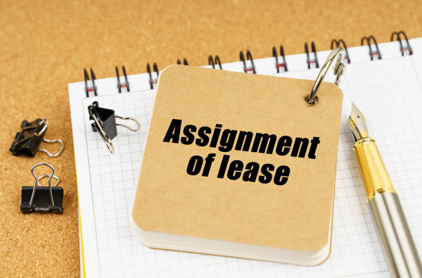 istock On the table is a pen and a notebook with the inscription - Assignment of lease 1357075794