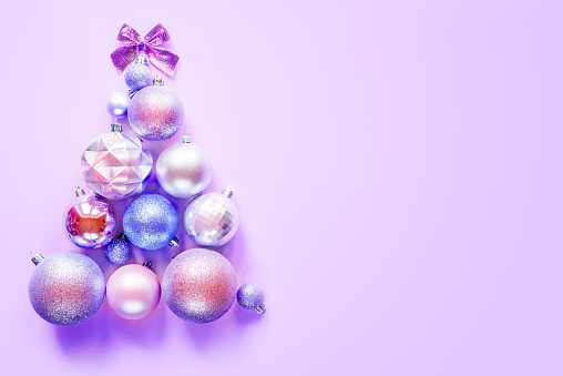 Innovative Christmas tree made of Christmas ornaments on purple background, creative Christmas and New Year layout for mock up template design with copy space
