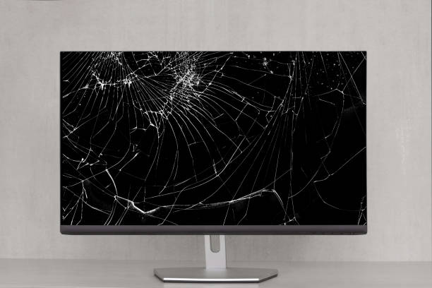 istock computer monitor with a broken screen in cracks on a gray background close-up 1357077521