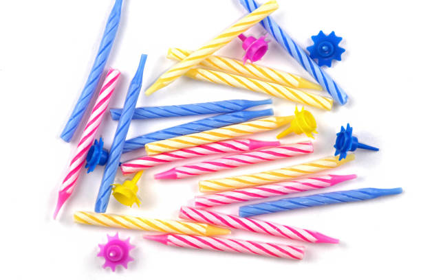 Candelabra with burning yellow candles on pink background.