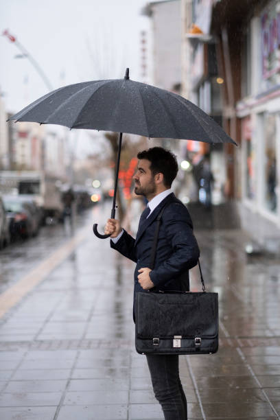 istock Happy Businessman In The Rain 1357079498