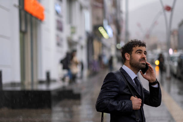 istock Happy Businessman In The Rain 1357080231