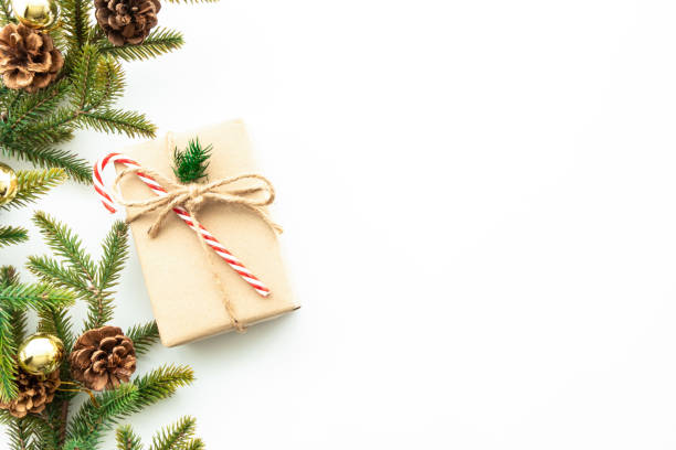 istock Beautiful Christmas background with gift box, decorate with pine branch and pine cone over white background. Top view with copy space, flat lay. 1357080273