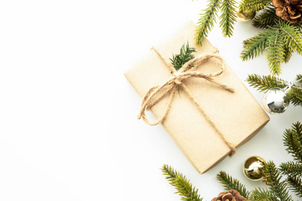 istock Beautiful Christmas background with gift box, decorate with pine branches over white background. Top view with copy space, flat lay. 1357080349