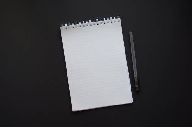 istock A notepad with a blank page and a pen on a dark background 1357082946