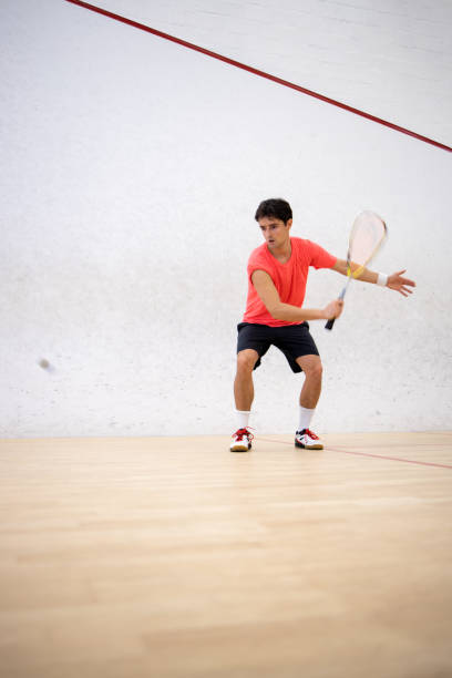 istock Squash player in action on a squash court 1357086992