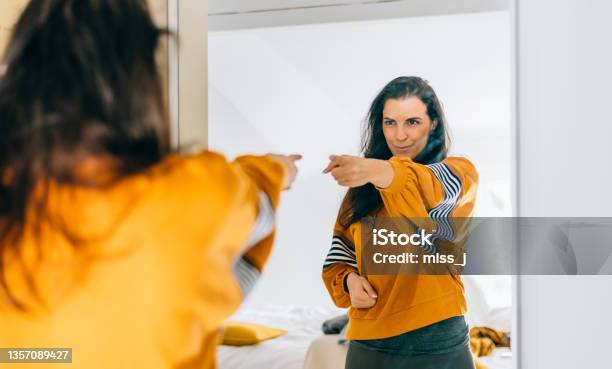 Self Confident Single Woman Pointing Finger At Her Reflection In Mirror Dancing And Felling Good Stock Photo - Download Image Now