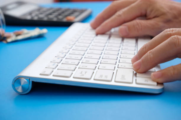 istock Man hands on the keyboard of a personal computer in the office or at home, suitable for both freelancing and office content. 1357092821