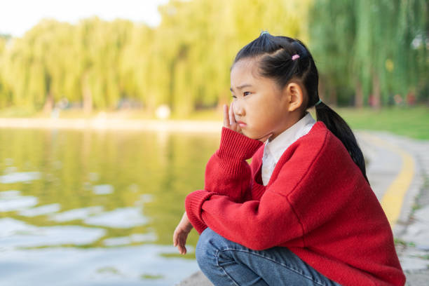 Thinking Little Girl Thinking Little Girl sad girl crouching stock pictures, royalty-free photos & images