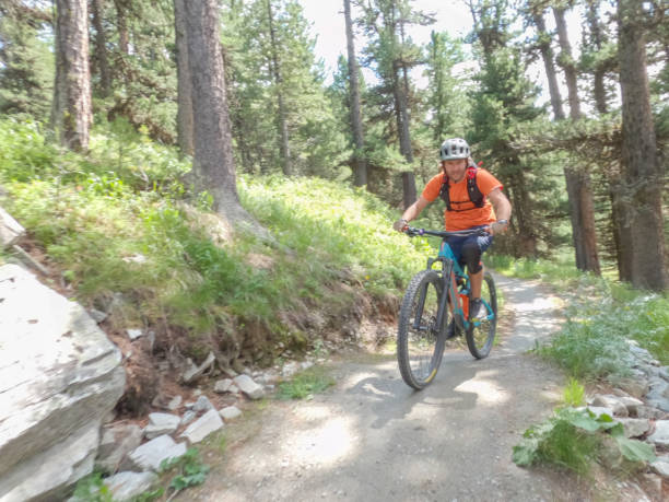 istock Man mountain biker descending steep trail 1357095075