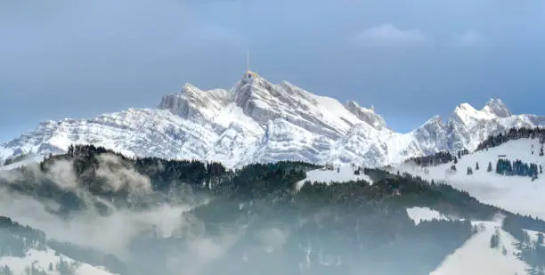 Stunning view of the famous Santis (SÃ¤ntis) peak on a foggy winter day, eastern Switzerland