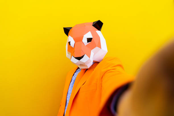 istock Cool man wearing 3d origami mask 1357096574