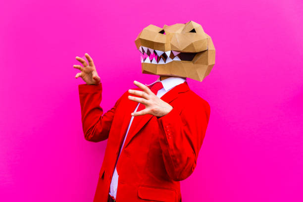 Cool man wearing 3d origami mask with stylish colored clothes - Creative concept for advertising, animal head mask doing funny things on colorful background