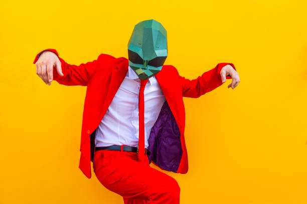 Cool man wearing 3d origami mask with stylish colored clothes - Creative concept for advertising, animal head mask doing funny things on colorful background