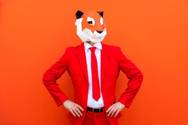 Cool man wearing 3d origami mask with stylish colored clothes - Creative concept for advertising, animal head mask doing funny things on colorful background