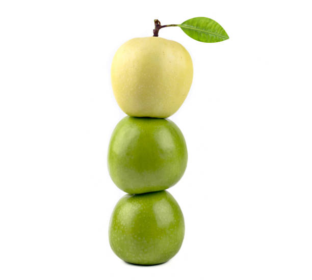 istock One Apple yellow on two apple green isolated on white background. 1357099956