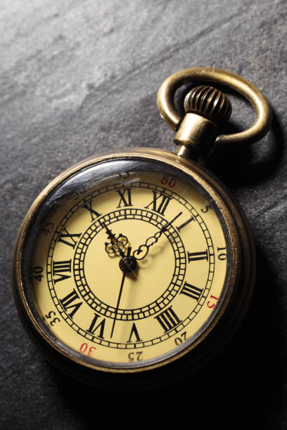 istock Vintage antique pocket watch on dark stone background 1357100237