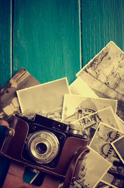 istock Vintage photo camera and old photos. 1357100401