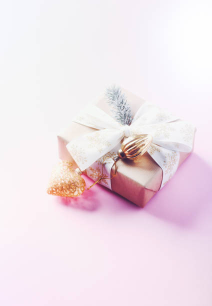 istock Christmas baubles and Christmas present. Bright paper background. Copy space. 1357100425