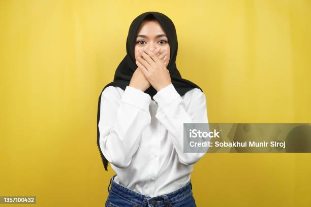 Beautiful Young Asian Muslim Woman Shocked Surprised Disbelieving Getting Shocking Information With Hands Covering Mouth Isolated On Yellow Background Stock Photo - Download Image Now