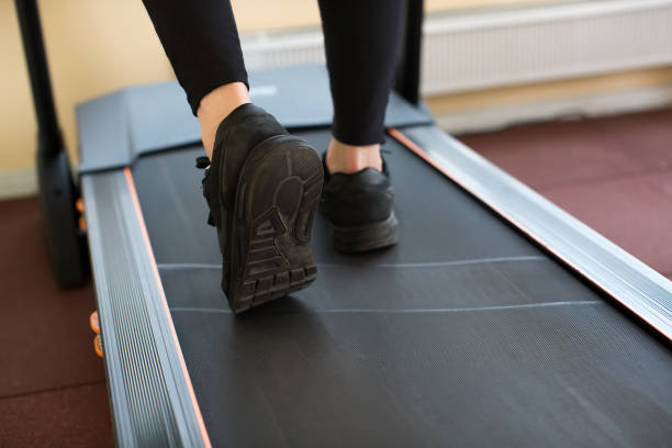 istock Man running in a gym on a treadmill 1357101552