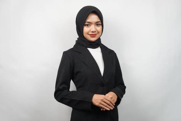 beautiful young asian muslim business woman confident and smiling, isolated on gray background - japanese ethnicity women asian and indian ethnicities smiling imagens e fotografias de stock