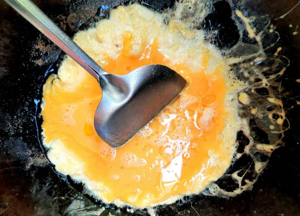 istock Making Fried Eggs in cooking pan - food preparation. 1357103062
