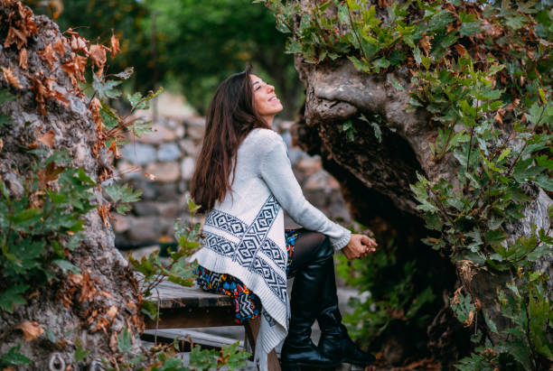 istock Beautiful Woman in Front of Plane Tree 1357105561