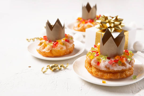 istock Roscon de reyes, spanish three kings Christmas sweet cake with winter decorations on white background 1357106673