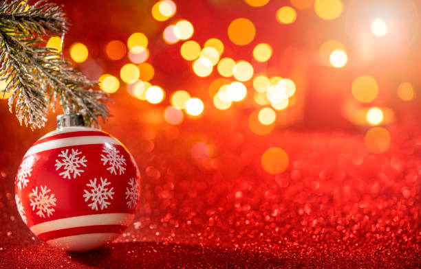 istock Red bauble with snowflakes drawing and Christmas lights on glowi 1357107740