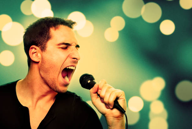istock Retro image of man singing into microphone 1357107761