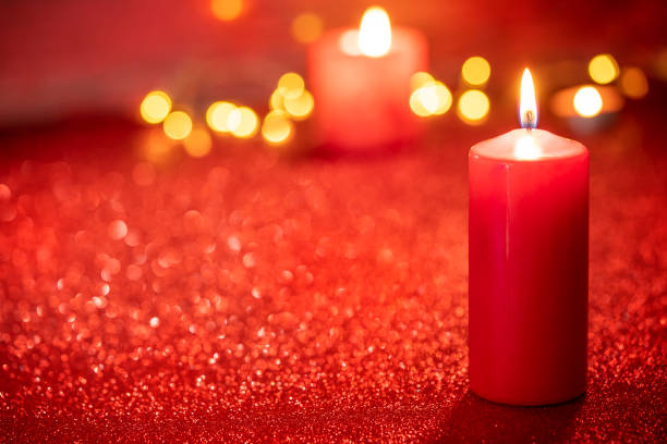 istock Red candle light Christmas candlelight on glowing flame sparklin 1357107955