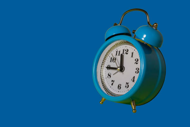 istock Alarm clock over blue. Time concept. Blue alarm clock morning time. Blue alarm clock with copy space. 1357109616