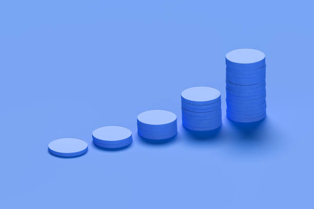 istock Growth concept: stacks of blue coins on blue background piling up to higher and higher values. 1357109709