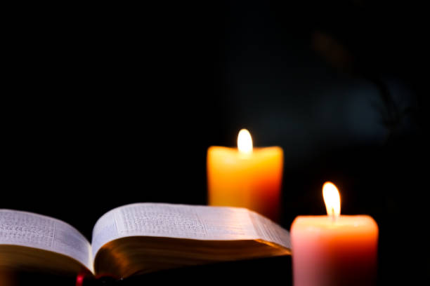 istock Bible, candle and holy cross 1357110704