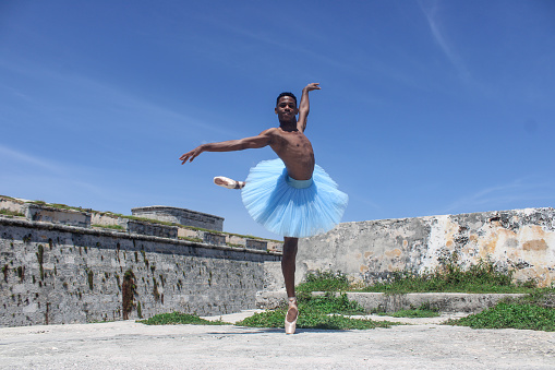 Portrait of a young Cuban dancer dancing in Havana with a dancer's costume.