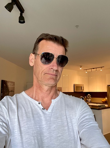 Senior man with new haircut and sunglasses