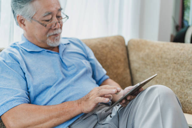 istock Mature man use digital tablet at home. 1357115448