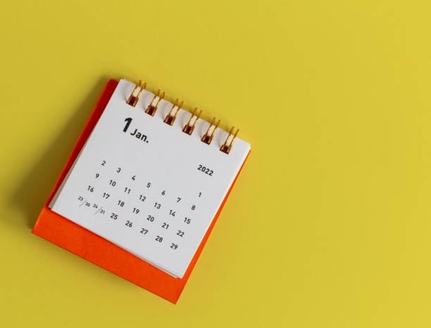 istock Desktop calendar for January 2022 on a yellow background. 1357117015