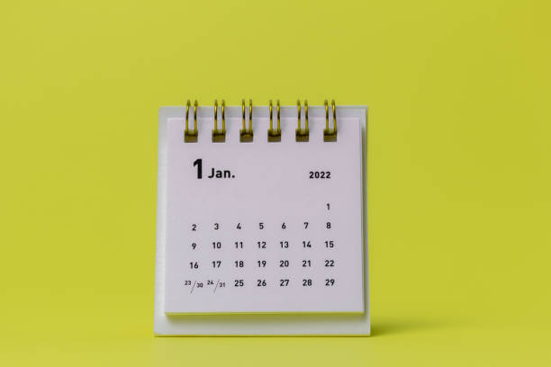 istock Desktop calendar for January 2022 on a yellow background. 1357117016