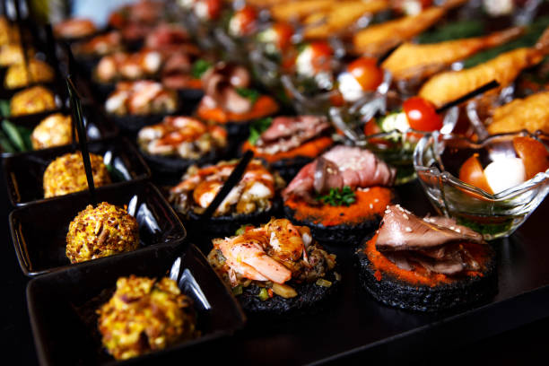 istock Banquet Meat Bar. Cold snacks with vegetables, fish and rucola on bread, canapes 1357126418