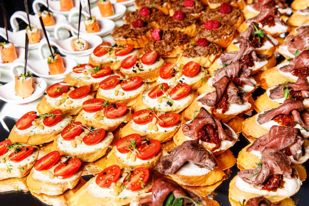 istock Banquet Meat Bar. Cold snacks with vegetables, fish and rucola on bread, canapes 1357126480