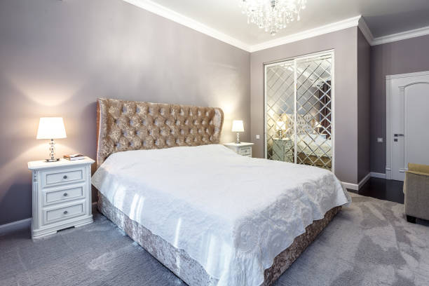 istock luxury hotel bedroom. Bed with carriage coupler headboard 1357126602