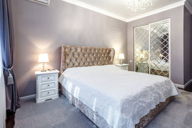 istock luxury hotel bedroom. Bed with carriage coupler headboard 1357126605