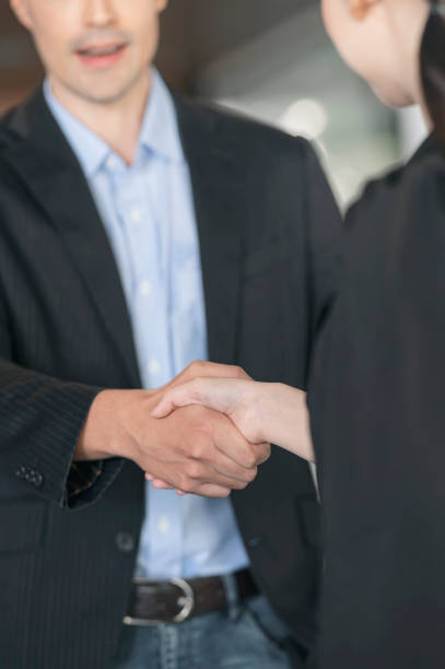 istock Business people shaking hands. 1357126899